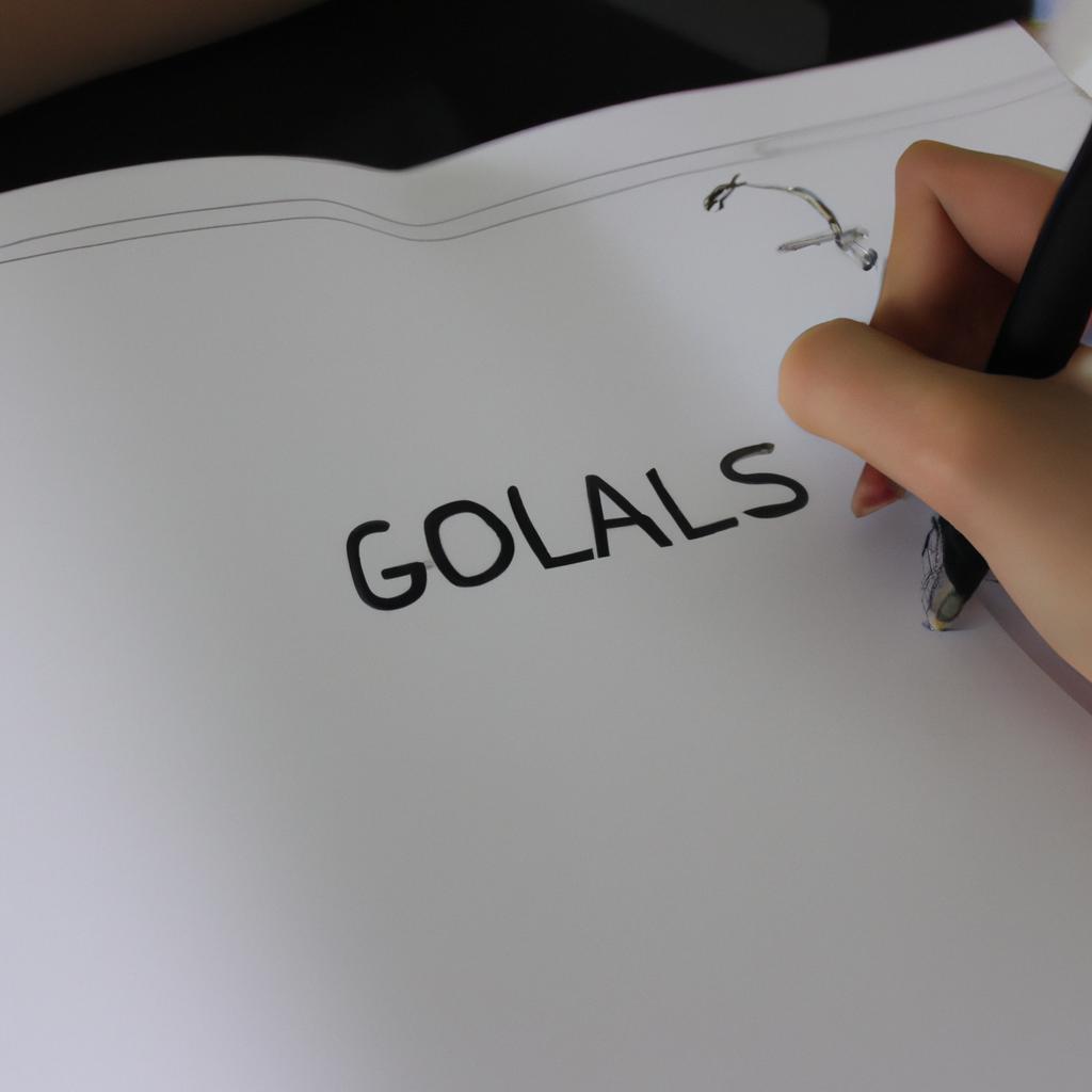 Person writing goals on paper